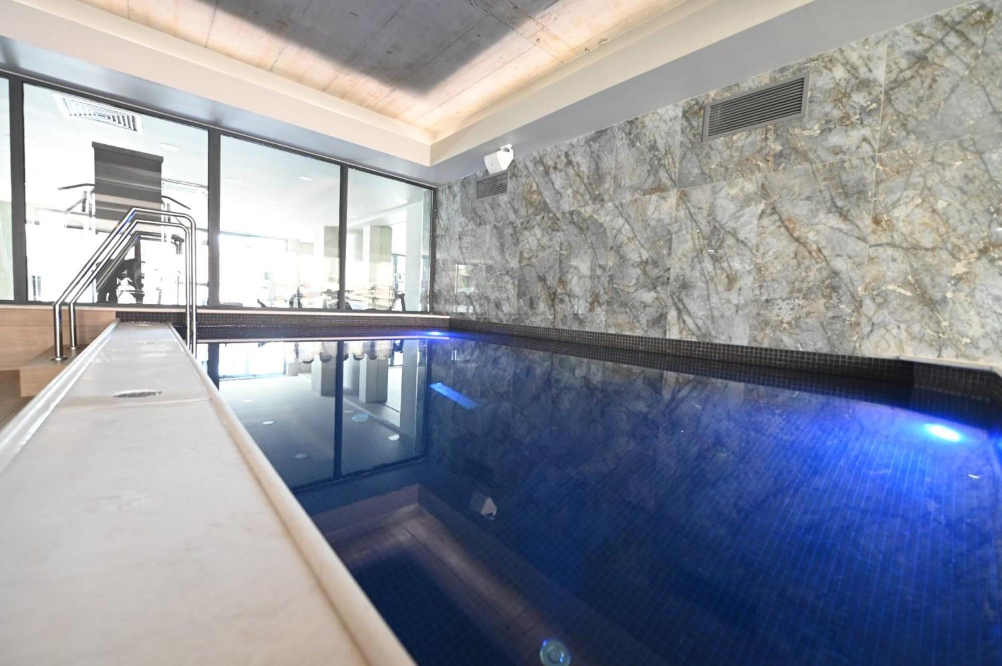 Aniroc Signature Hotel Arad Kültér fotó A pool with a glass wall